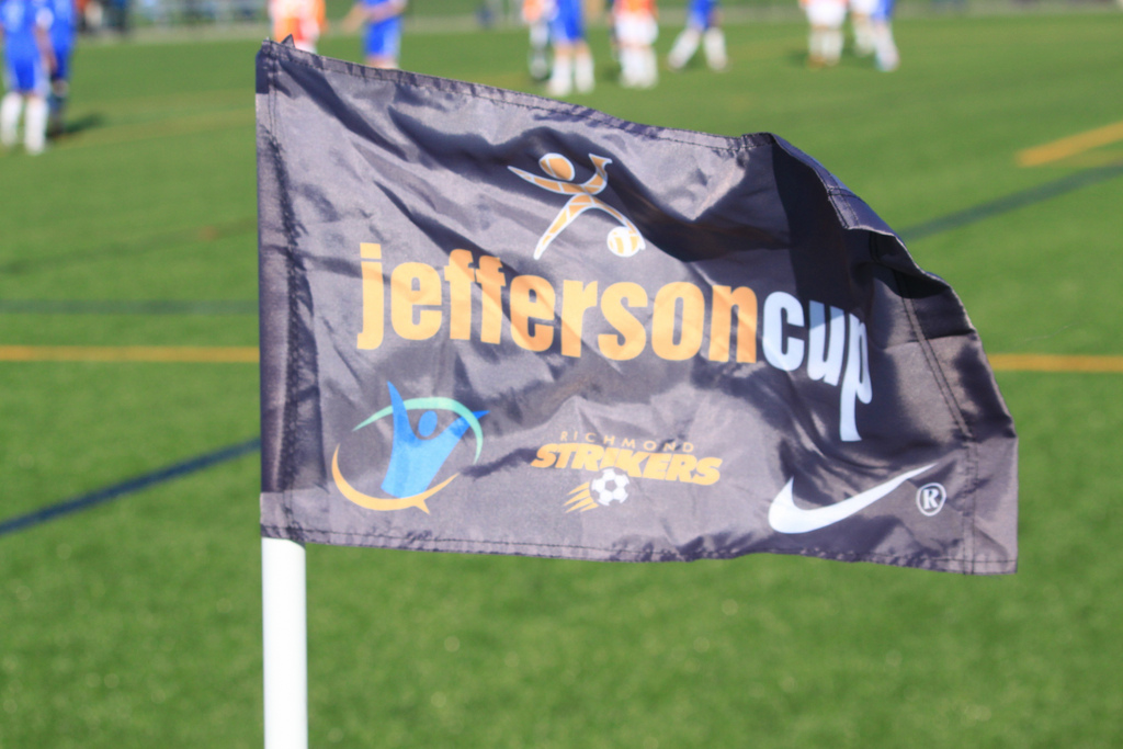 A corner flag flaps in the heavy winds on the tournament's opening day.