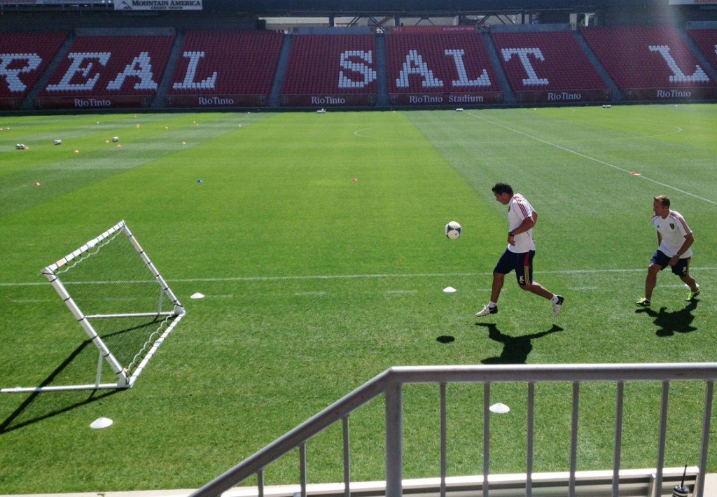 Assistant coach Jeff Cassar (left) and head coach Jason Kreis play on a rebound net before Real Salt Lake training. (Photo: Liviu Bird/SoccerWire.com)