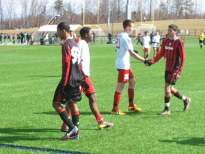 ASA Milan Black Hawks (in black/red) shake hands with Upper Freehold/Allentown Strikers after their 2-2- draw in 2013 Jefferson Cup play.