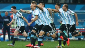 Lionel Messi of Argentina and his team mates celebrate as they win the penalty shoot out and qualify for the final to face Germany